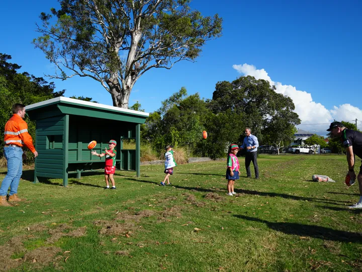 BMD Communications Graduate Ethan, BMD Executive General Manager of Constructions Jeff Gallus, and Wynnum Manly Juniors Coaching Director Mick Haggarty practice with junior players.